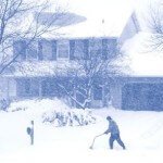a-snowy-winter-scene-of-a-man-shoveling-snow-during-snowfall